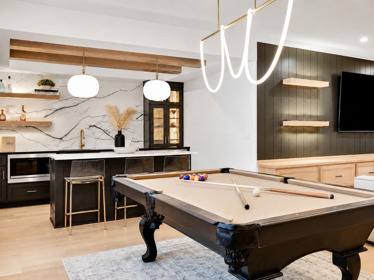 Finished lower-level lounge with pool table and sectional seating